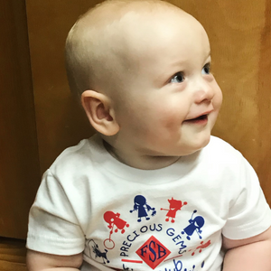 Baby smiling wearing a Farmers Savings bank precious gems shirt